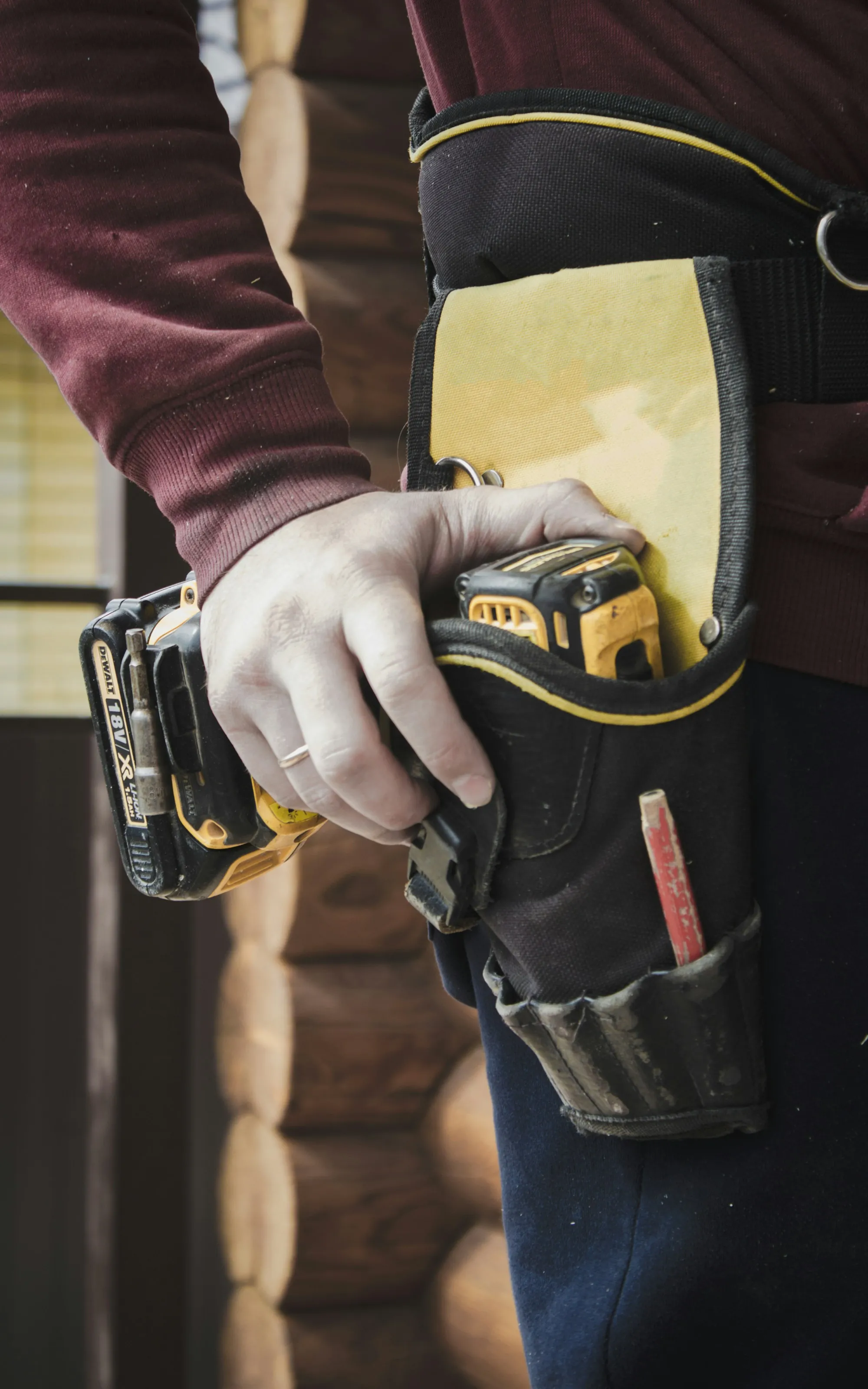 Hand drawing a cordless drill from a tool belt
