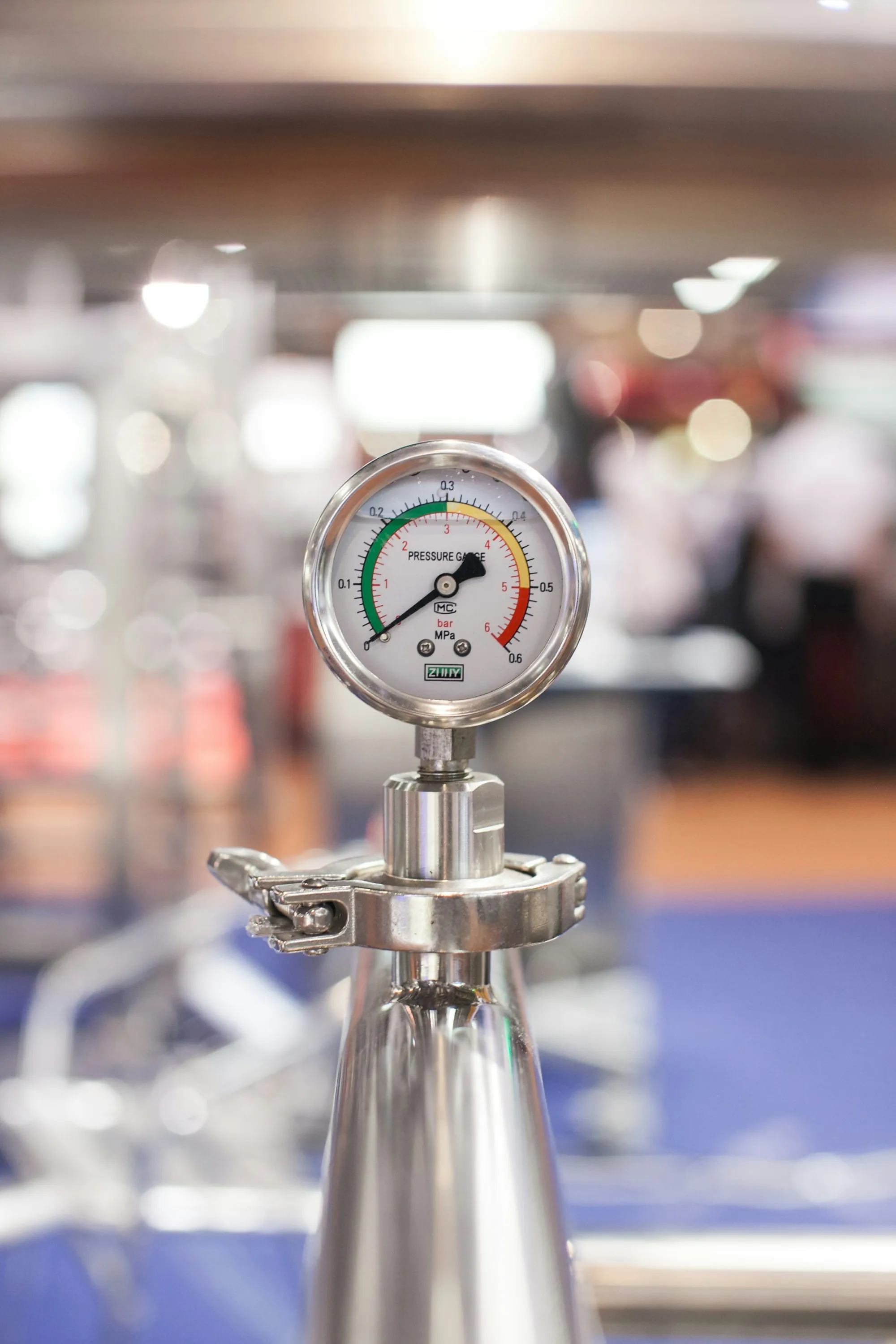 Pressure gauge with a colored dial on a fitting